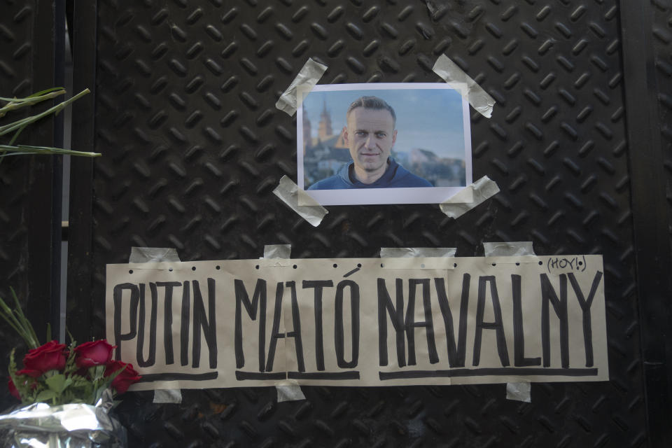 A photo of Alexei Navalny and a sign with a message that reads in Spanish: "Putin killed Navalny" are taped to a gate outside the Russian embassy in Buenos Aires, Argentina, Friday, Feb. 16, 2024. Navalny, who crusaded against official corruption and staged massive anti-Kremlin protests as President Vladimir Putin's fiercest foe, died Friday in the Arctic penal colony where he was serving a 19-year sentence, Russia's prison agency said. He was 47. (AP Photo/Victor R. Caivano)