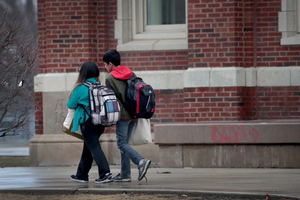 CHICAGO, ILLINOIS  - MARCH 16: Students leave Lane Tech College Prep High School at the end of the school day on March 16, 2020 in Chicago, Illinois. Schools in the city have been ordered to close beginning tomorrow for at least the next two weeks in an attempt to stop the spread of COVID-19. (Photo by Scott Olson/Getty Images)