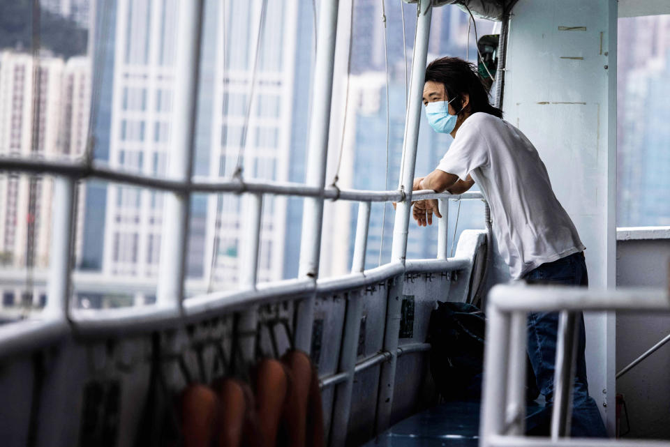 A man looks out from a ferry in Hong Kong (Isaac Lawrence / AFP via Getty Images)