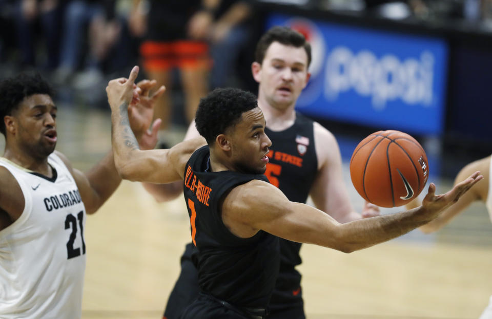 Oregon State guard Sean Miller-Moore, front, reaches out for a rebound as forward Payton Dastrup, back right, and Colorado forward Evan Battey look on in the second half of an NCAA college basketball game Sunday, Jan. 5, 2020, in Boulder, Colo. Oregon State came from behind to win 76-68. (AP Photo/David Zalubowski)