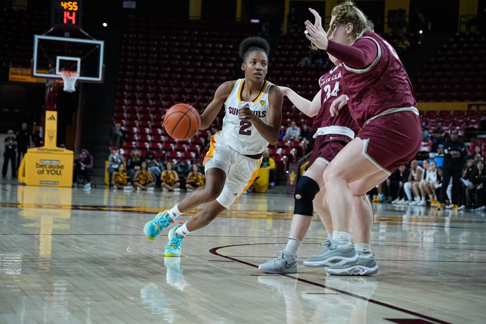 Jaddan Simmons (2) of the ASU Sun Devils moves the ball past Tess Heal (34) and Emma Shaffer (52) of the SCU Broncos as Santa Clara University plays Arizona State University at Desert Financial Arena on Dec. 30, 2023, in Tempe.