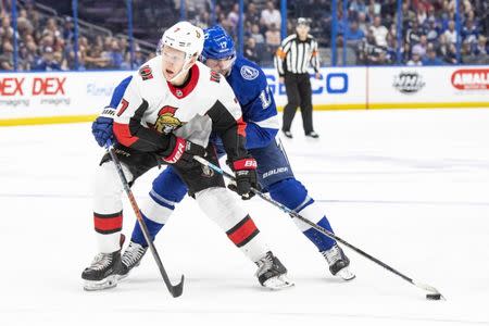 Nov 10, 2018; Tampa, FL, USA; Ottawa Senators left wing Brady Tkachuk (7) and Tampa Bay Lightning center Alex Killorn (17) fight for the puck during the second period at Amalie Arena. Douglas DeFelice-USA TODAY Sports