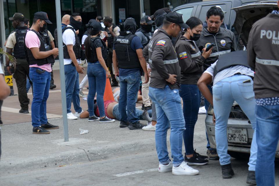 Ecuadorean police officers guard the arrested suspects outside Ecuador's TC television channel after unidentified gunmen burst into the state-owned television studio live on air on Jan. 9, 2024, in Guayaquil, Ecuador.