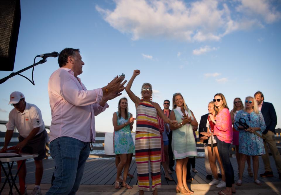 Nick Coppola (left), father of Cole Coppola, finishes singing "Happy Birthday" for his son at the end of the Live Like Cole Dock commemoration at Royal Palm Pointe on Wednesday, Sept. 25, 2019, in Vero Beach. The ceremony was held on what would have been the 21st birthday for Cole Coppola, who was killed in 2014 at the age of 16 when he was hit by an intoxicated driver. Cole's mother, Elaine Coppola (not pictured), said, "You know, today is Cole's 21st birthday, and the weather has been so tricky lately, I just think that Cole was actually looking over us." She went on to add her son was not one for attention, but added, "I think just the fact that they have two safe spaces for kids and people and families to play and fish — he would be proud of this." One of the dock's sponsors, Jodi Harvey (center), cheers among the crowd of family and friends.