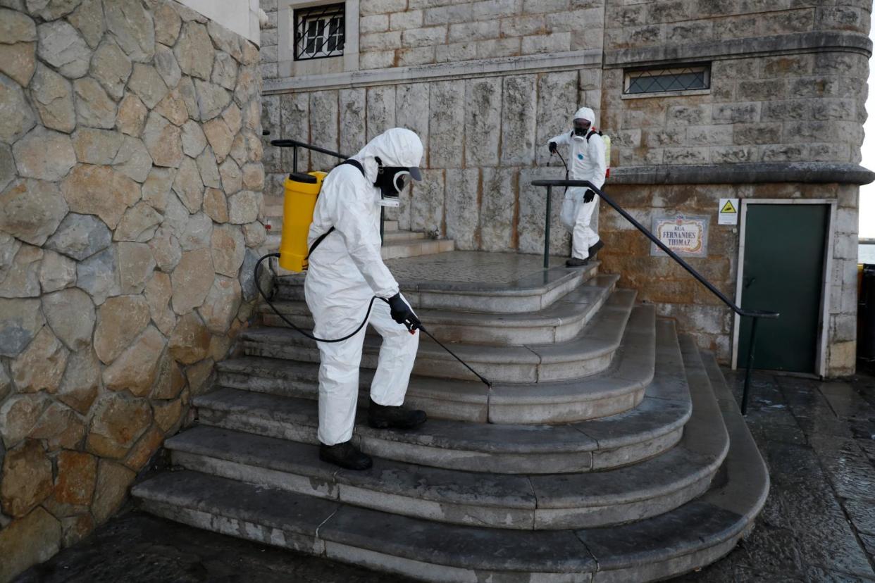 Municipal workers disinfect streets at downtown Cascais, Portugal: REUTERS