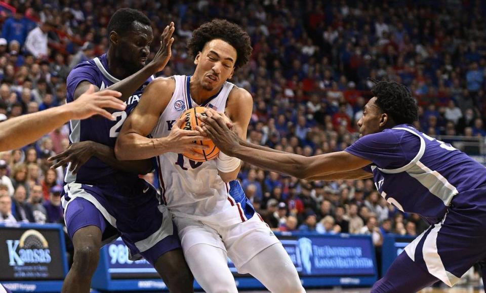 KU’s Jalen Wilson drives between KSU’s Abayomi Iyiola, left, and Nae’Qwan Tomlin during the second half of a game at Allen Fieldhouse on Jan. 31, 2023.