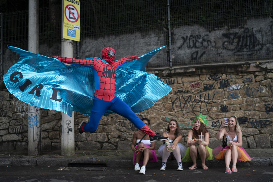 A reveler dressed in Spider-Man costume strikes a pose at the "Ceu na Terra" or Heaven on Earth street party in Rio de Janeiro, Brazil, Saturday, Feb. 22, 2020. From very early in the morning revelers take the streets of the bohemian neighborhood Santa Teresa for one of the many block parties during the Carnival celebrations in the city. (AP Photo/Leo Correa)