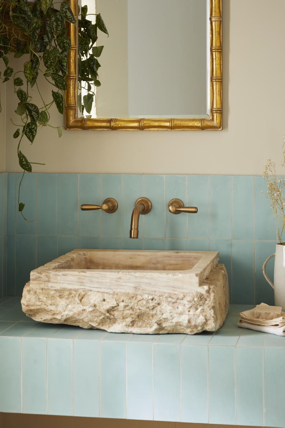 A modern bathroom with jade-toned tiles