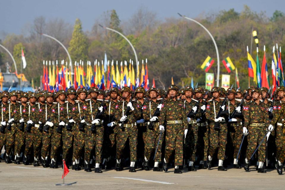 Members of the Myanmar military march at a parade ground to mark the country's Independence Day (AFP via Getty Images)