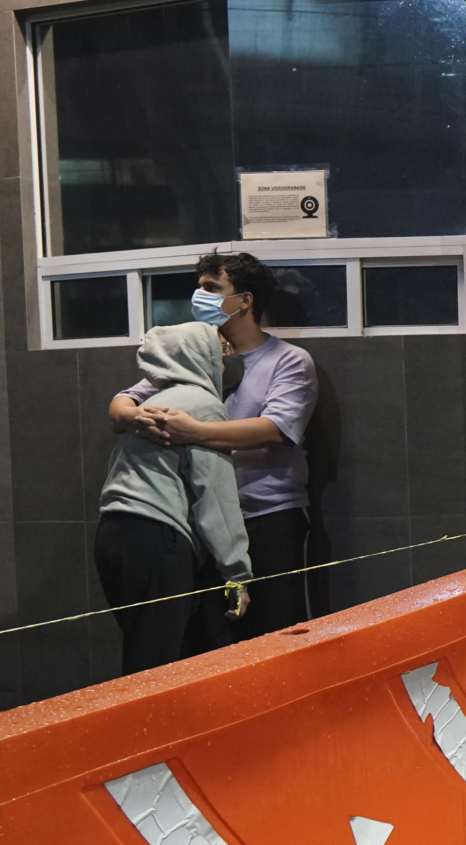 A couple embraces outside a building after a strong earthquake, in Mexico City, Tuesday, Sept. 7, 2021. The quake struck southern Mexico near the resort of Acapulco, causing buildings to rock and sway in Mexico City nearly 200 miles away. (AP Photo/Marco Ugarte)