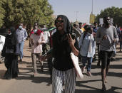 Sudanese calling for a civilian government march near the presidential palace in Khartoum, Sudan, Tuesday, Nov. 30, 2021. Security forces have fired tear gas at anti-coup protesters in the Sudanese capital on Tuesday, in the latest demonstrations against a military takeover that took place last month. (AP Photo/Marwan Ali)