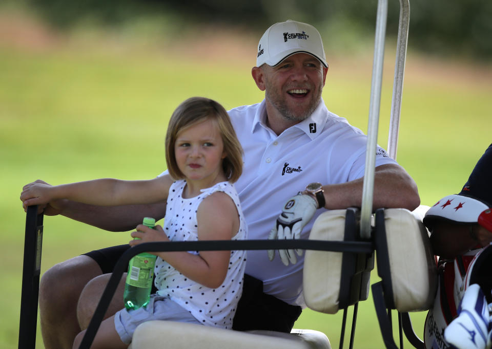 Mike Tindall rides on a golf cart with his daughter Mia during the Celebrity Cup charity fundraiser golf tournament at the Celtic Manor Resort in Newport, Gwent. (Photo by Andrew Matthews/PA Images via Getty Images)