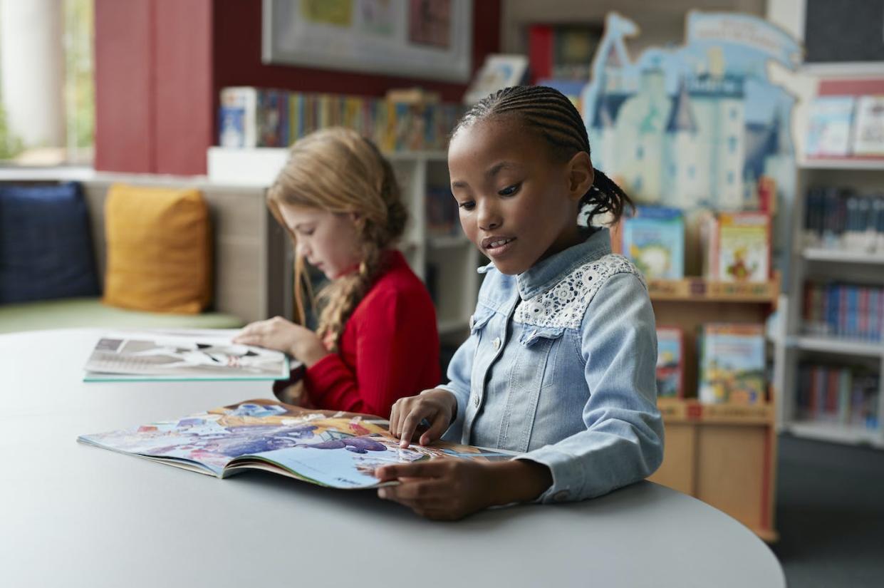 As the pandemic continues to pose new challenges, libraries are finding ways to better meet the needs of their communities. <a href="https://www.gettyimages.com/detail/photo/schoolgirls-reading-books-in-school-library-royalty-free-image/1049277458" rel="nofollow noopener" target="_blank" data-ylk="slk:Klaus Vedfelt/DigitalVision via GettyImages;elm:context_link;itc:0;sec:content-canvas" class="link ">Klaus Vedfelt/DigitalVision via GettyImages</a>