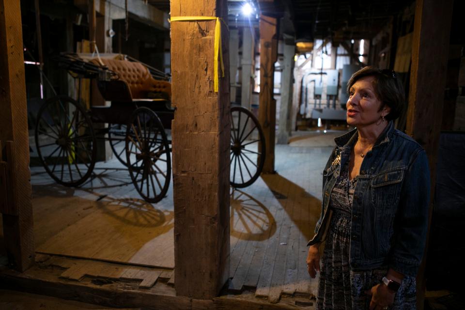 Bruna Brundige, President of the Canal Winchester Area Historical Society, stands by an old buggy inside of the grain elevator at the Canal Winchester Area Historical Society on May 26, 2023, in Canal Winchester, Ohio.