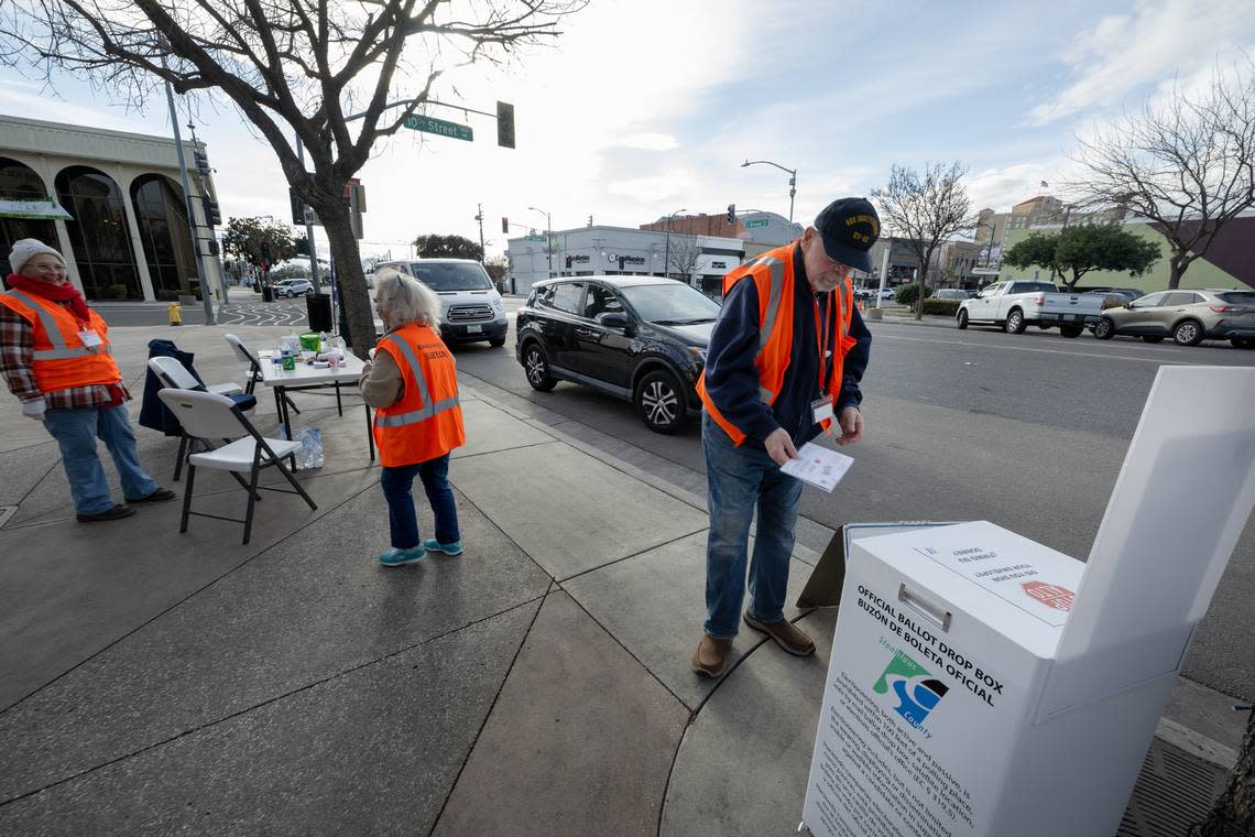 Election officer Robert Muse handles ballots at a drive-up ballot drop station outside the Gallo Center for the Arts in Modesto, Calif., Tuesday, March 5, 2024.