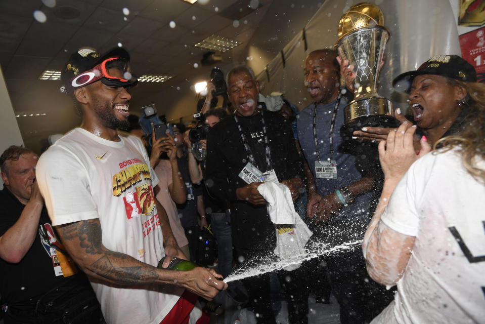 Toronto Raptors forward Kawhi Leonard sprays his mother, Kim Robertson, with sparkling wine after the Raptors defeated the Golden State Warriors 114-110 in Game 6 of basketball’s NBA Finals, Thursday, June 13, 2019, in Oakland, Calif. (Frank Gunn/The Canadian Press via AP)