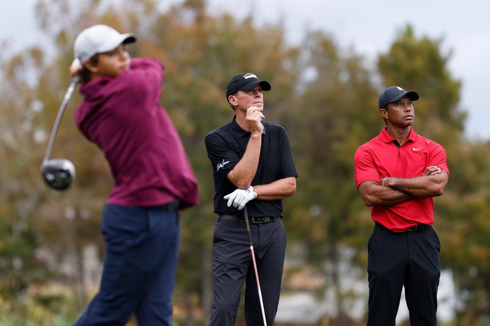 Charlie Woods unloads a tee shot while his father and Steve Stricker watch during last weekend's PNC Championship in Orlando.