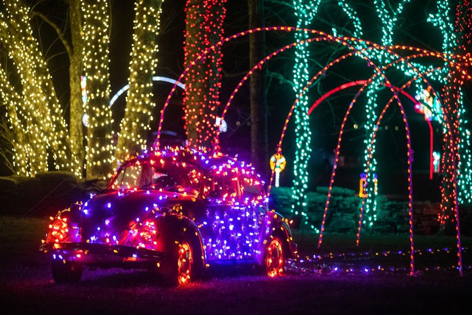 A Volkswagen Beetle is wrapped in holiday lights for the Peace, Love & Lights drive-thru holiday light show at Bethel Woods Center for the Arts.