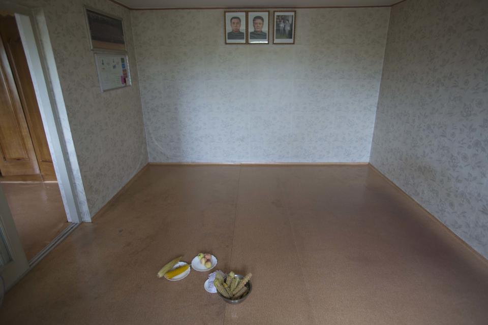 In this Aug. 10, 2012 photo, bowls of boiled corn and peaches sit on the floor after they were served as a snack inside a North Korean farmhouse at Tongbong cooperative farm in Hamju County, South Hamgyong Province, North Korea. It has been a tough year for North Korea's farmers, who grappled with an extended dry spell in the spring, followed by heavy rains from a series of summer storms and typhoon. The U.N. is launching a field mission across North Korea to gauge the state of the food situation. (AP Photo/David Guttenfelder)