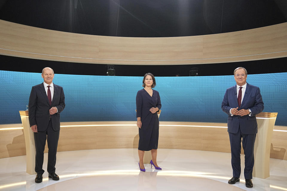 From left, Chancellor candidates Olaf Scholz (SPD), Annalena Baerbock (Green Party) and Armin Laschet (CDU) stand in the TV studio in Berlin, Sunday, Sept. 12, 2021. With two weeks left before Germany’s national election, the three candidates for chancellorship are facing off Sunday in the second of three televised election debates. (Michael Kappeler/Pool via AP)
