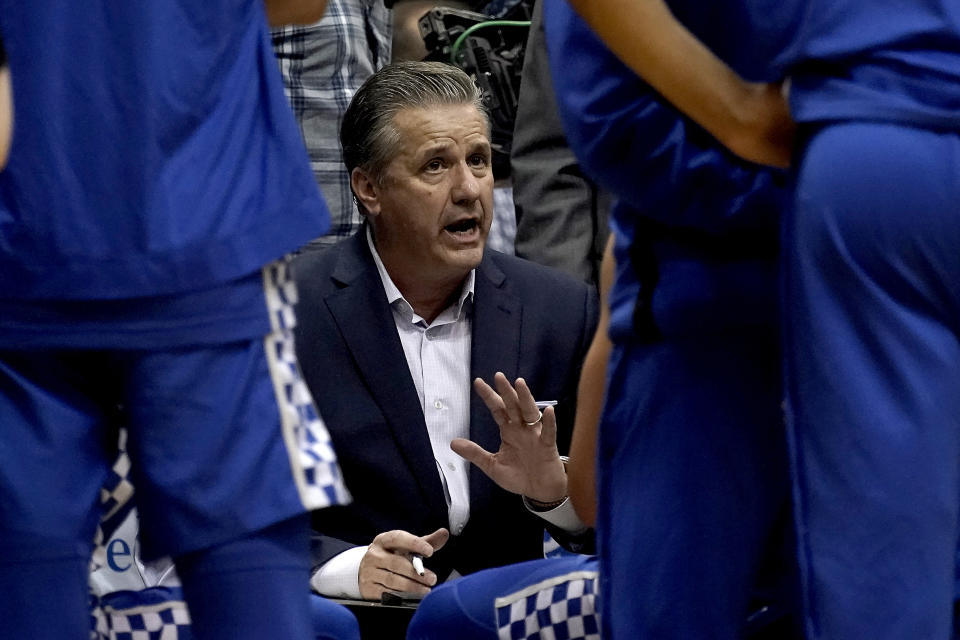 Kentucky head coach John Calipari talks to his players during the second half of an NCAA college basketball game against Kansas Saturday, Jan. 29, 2022, in Lawrence, Kan. Kentucky won 80-62. (AP Photo/Charlie Riedel)