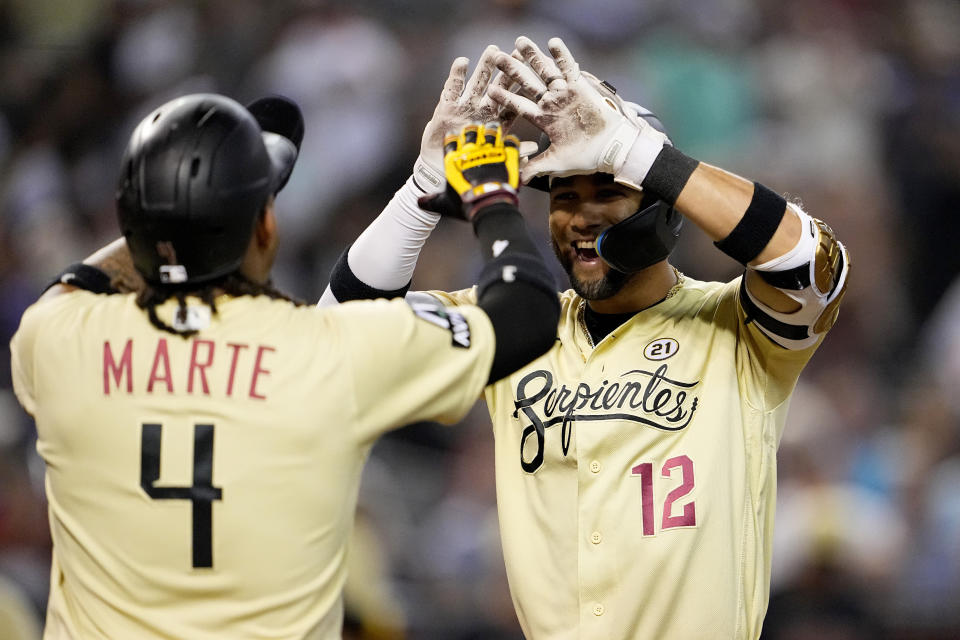 Arizona Diamondbacks' Lourdes Gurriel Jr. celebrates his three run home run against the Chicago Cubs with Ketel Marie (4) during the first inning of a baseball game, Friday, Sept. 15, 2023, in Phoenix. (AP Photo/Matt York)