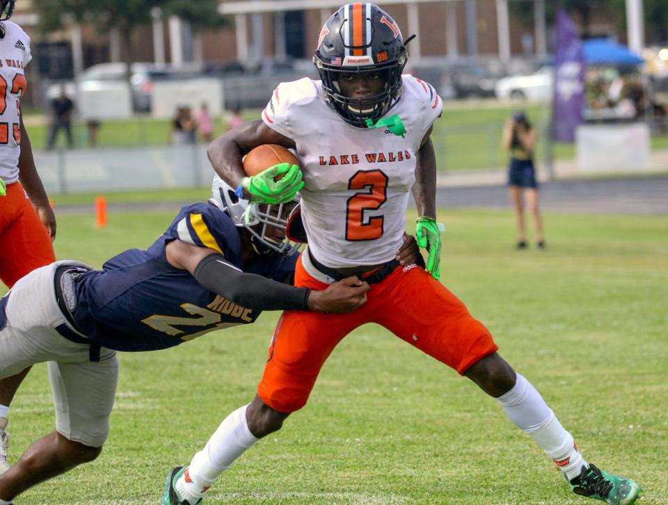 Lake Wales' Carlos Mitchell tries to esape the tackle of Ridge Community's Damil Palmer.