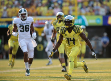 Sep 6, 2014; Eugene, OR, USA; Oregon Ducks defensive back Ifo Ekpre-Olomu (14) runs down the field against the Michigan State Spartans at Autzen Stadium. (Scott Olmos-USA TODAY Sports)