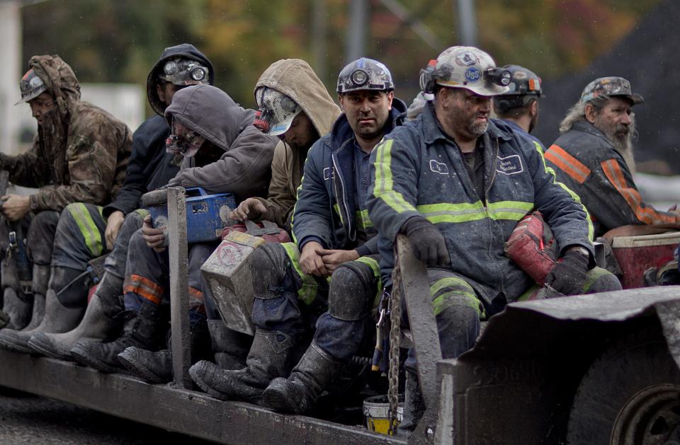 In this Oct. 15, 2014, photo, coal miners return on a buggy after working a shift underground at the Perkins Branch Coal Mine in Cumberland, Ky. As recently as the late 1970s, there were more than 350 mines operating at any given time in Harlan County.