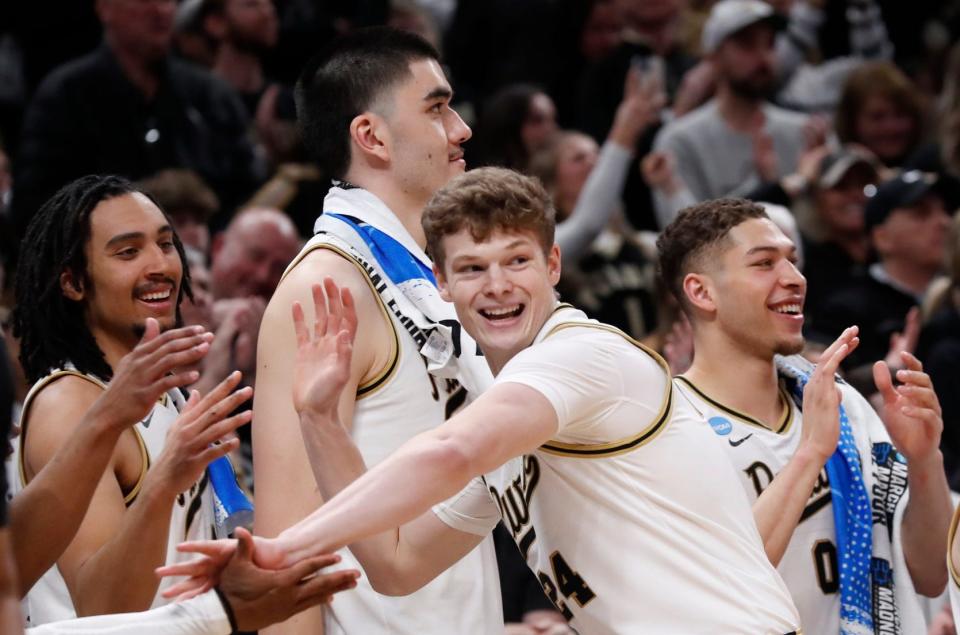 Purdue forward Sam King, front, celebrates with the Boilermakers' bench after scoring during their NCAA Tournament game against Utah State on Sunday in Indianapolis. The Boilermakers won 106-67. The NCAA Tournament's Sweet 16 is this weekend.