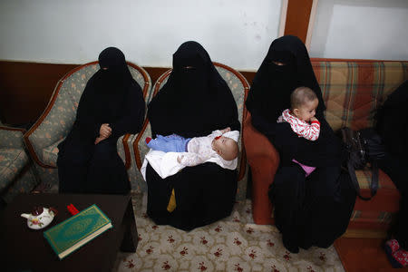 Uighur refugees wait during an interview with Reuters in Istanbul, Turkey, July 16, 2015. REUTERS/Osman Orsal