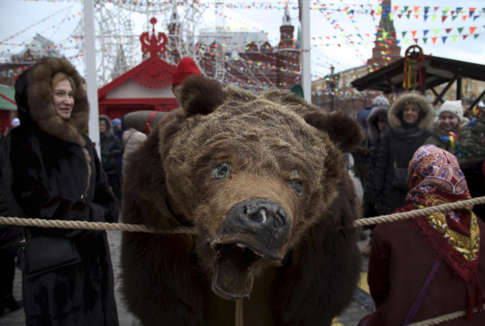 <p>A performer dressed as a bear entertains as people celebrate the start of Maslenitsa, or Pancake week, in Moscow, Russia on Feb. 19, 2017. Maslenitsa is a traditional Russian holiday marking the end of winter that dates back to pagan times.(Photo: Ivan Sekretarev/AP) </p>