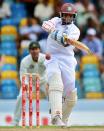 West Indies cricketer Shivnarine Chanderpaul plays a shot off Australian bowler Peter Siddle during the second day of the first-of-three Test matches between Australia and West Indies at the Kensington Oval stadium in Bridgetown on April 8, 2012. AFP PHOTO/Jewel Samad (Photo credit should read JEWEL SAMAD/AFP/Getty Images)