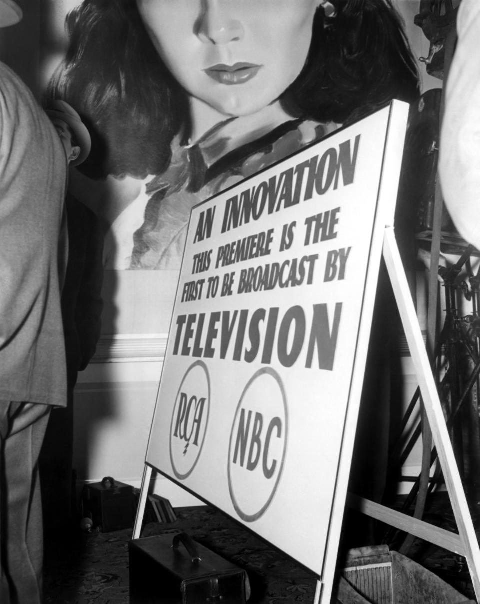 Poster with text: "An innovation. This premiere is the first to be broadcast by television" featuring RCA and NBC logos, and a drawing of a woman's face