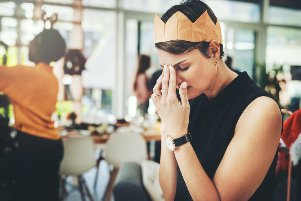 Woman feeling stressed at a party. (Getty Images)