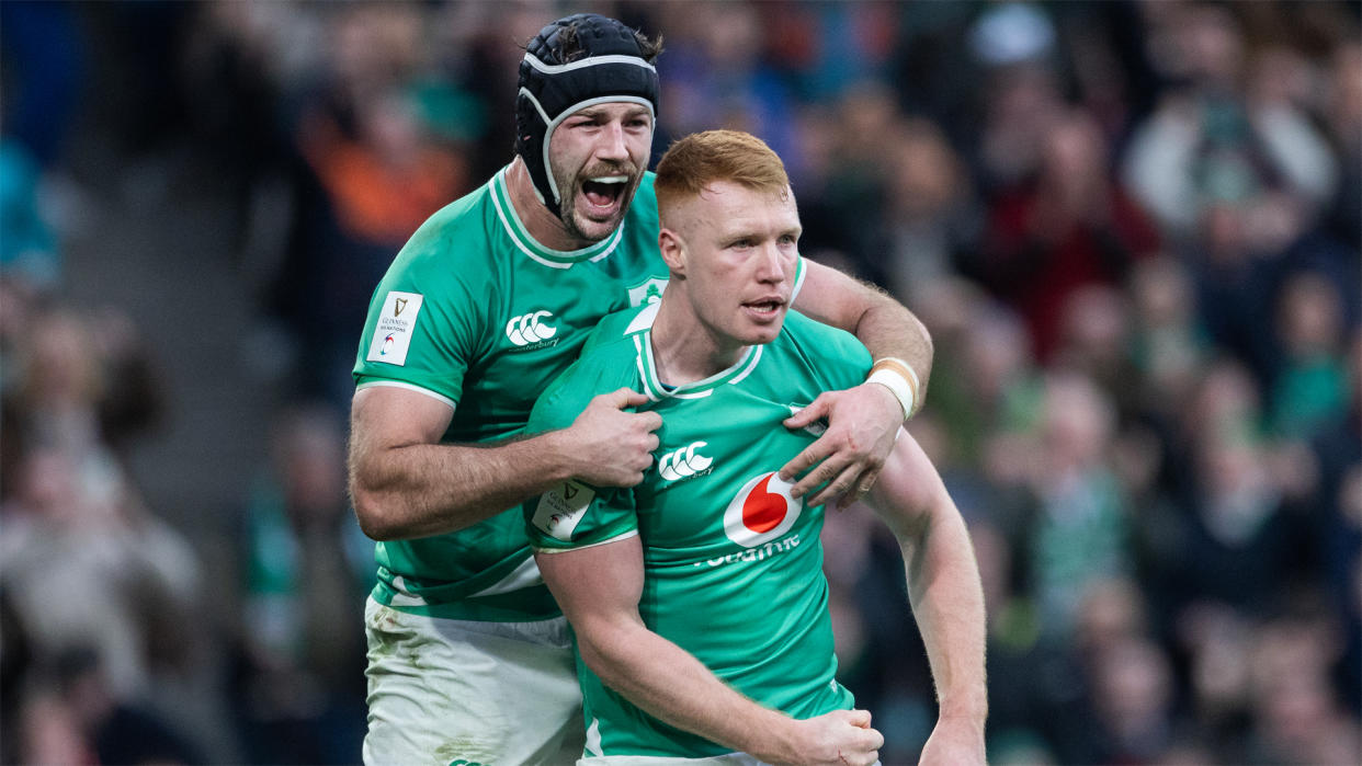  Caelan Doris helps Ciaran celebrate his debut try for Ireland. 