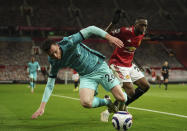 Liverpool's Andrew Robertson, left, duels for the ball with Manchester United's Aaron Wan-Bissaka during the English Premier League soccer match between Manchester United and Liverpool, at the Old Trafford stadium in Manchester, England, Thursday, May 13, 2021. (AP Photo/Dave Thompson, Pool)