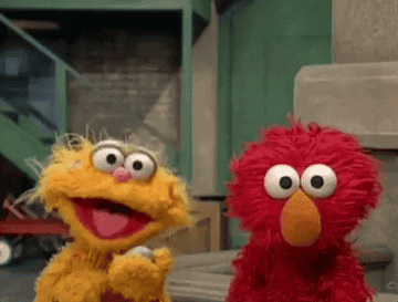 Sesame Street's characters Elmo and Zoe smiling