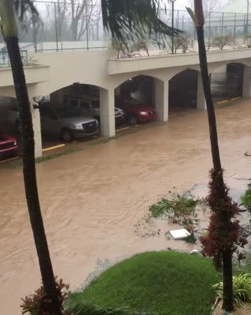 A flooded road is seen as Hurricane Maria hits Suan Juan, Puerto Rico September 20, 2017, in this still image from social media video. Gabriel Rosa/via REUTERS