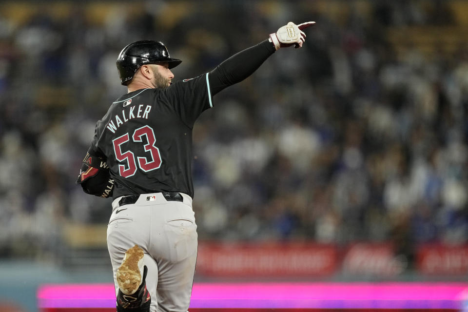 Arizona Diamondbacks' Christian Walker gestures toward his bullpen after hitting a solo home run during the sixth inning of a baseball game against the Los Angeles Dodgers Wednesday, May 22, 2024, in Los Angeles. (AP Photo/Mark J. Terrill)