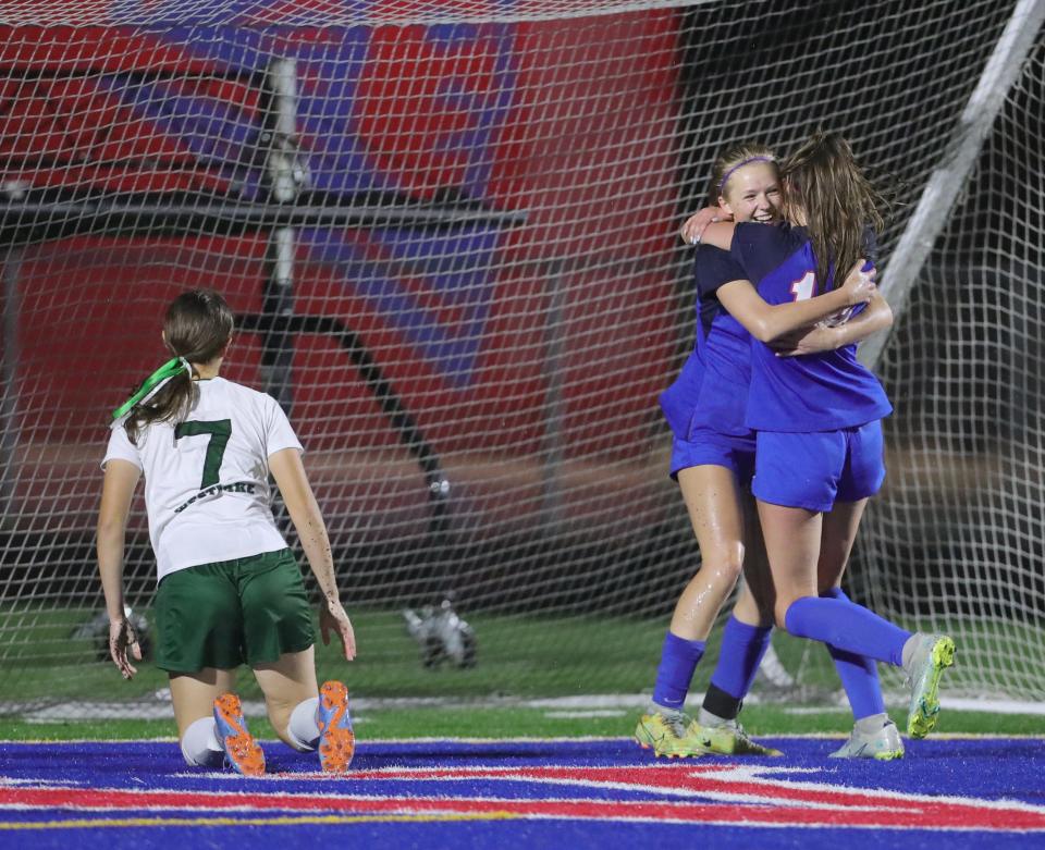 Revere's Zsofia Jakab and Taylor Catlett, far right, embrace after Jakab's game-winning overtime goal against Westlake in a Division I sectional final Thursday in Bath Township.