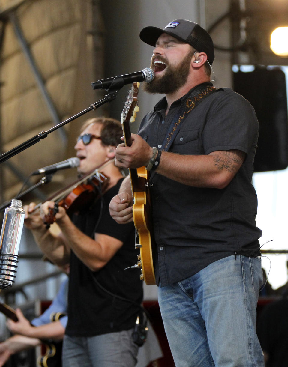 Zac Brown Band members Zac Brown, foreground, and Jimmy De Martini, perform with the group at the New Orleans Jazz and Heritage Festival in New Orleans, Friday, May 4, 2012. (AP Photo/Gerald Herbert)