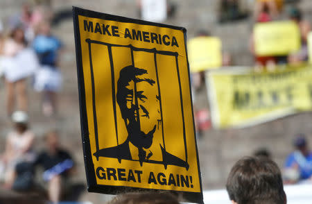 A placard is displayed during 'Helsinki Calling' protest ahead of meeting between the U.S. President Donald Trump and Russian President Vladimir Putin in Helsinki, Finland July 15, 2018. REUTERS/Ints Kalnins