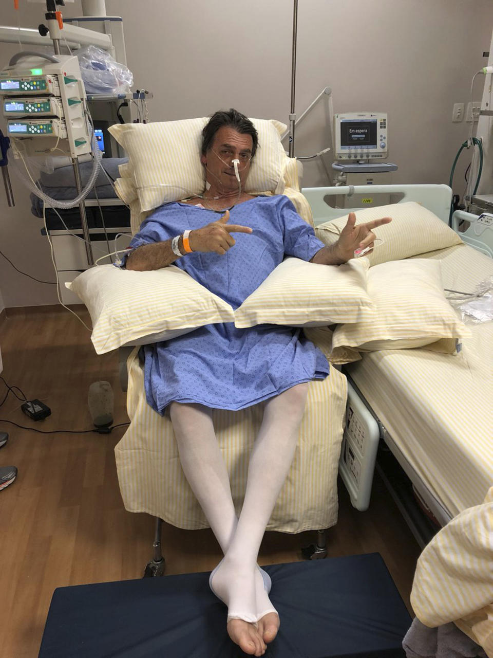 CORRECTS MONTH - In this handout photo provided by the National Social Liberal Party press office, presidential candidate Jair Bolsonaro poses for a photo while sitting in his hospital room at the Albert Einstein Hospital, in Sao Paulo, Brazil, Saturday, Sept. 8, 2018. The far-right congressman was stabbed on Thursday during a campaign rally. Bolsonaro, 63, suffered intestinal damage and serious internal bleeding, according to Dr. Luiz Henrique Borsato, one of the surgeons who operated on the candidate. (Flavio Bolsonaro/National Social Liberal Party via AP)