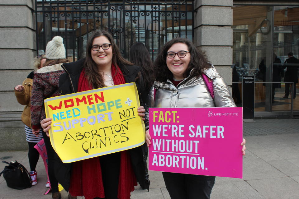 Roisin Ni Fhloinn, left, demonstrates against abortion outside Ireland's lower house of Parliament with her sister. (Photo: Jesselyn Cook/HuffPost)