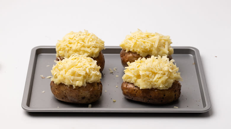 baked potatoes topped with mash and cheese