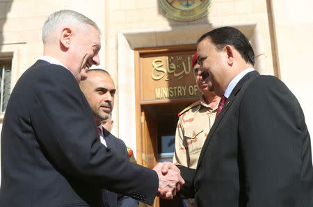 Iraq's Defence Minister Erfan al-Hiyali (R) welcomes U.S. Defense Secretary Jim Mattis at Ministry of Defence in Baghdad, Iraq February 20, 2017. REUTERS/Stringer