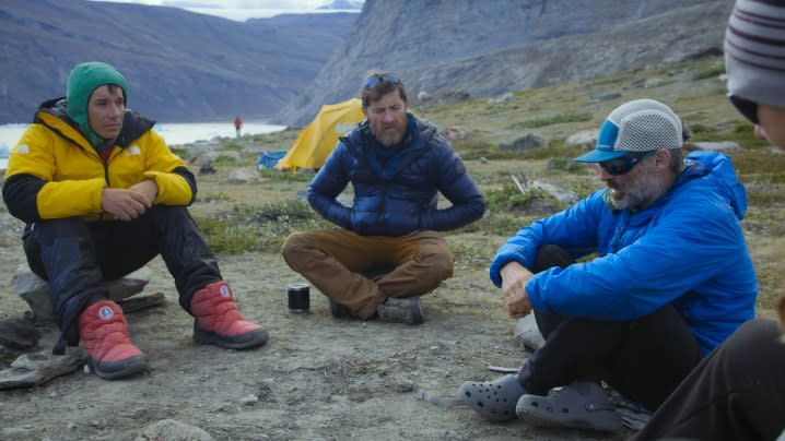 Alex Honnold, Aldo Kane, and Mikey Schaefer sit down and talk during a camp discussion. 