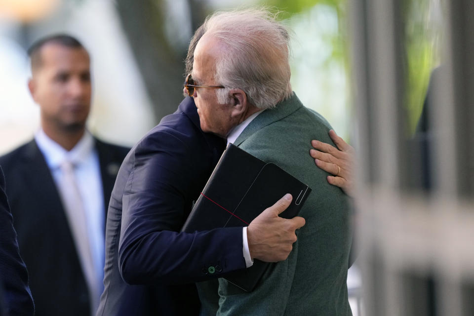 Hunter Biden hugs James Biden after arriving at the courthouse.