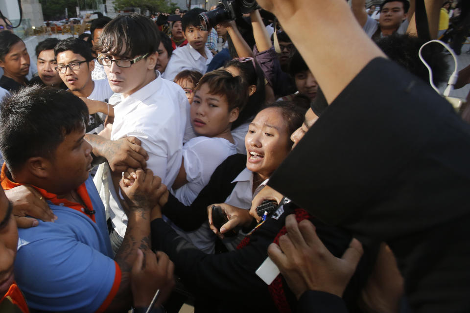Police officers drag student Chonthicha Jangrew, bottom center, during a protest marking the first anniversary of the military coup, in Bangkok, Thailand, May 22, 2015. Three years ago, tens of thousands of mostly young people in Thailand took to the streets in heated demonstrations seeking democratic reforms. Now, with a general election coming in three weeks, leaders of the country’s progressive movement are hoping to channel the same radical spirit for change though the ballot box. (AP Photo/Sakchai Lalit)